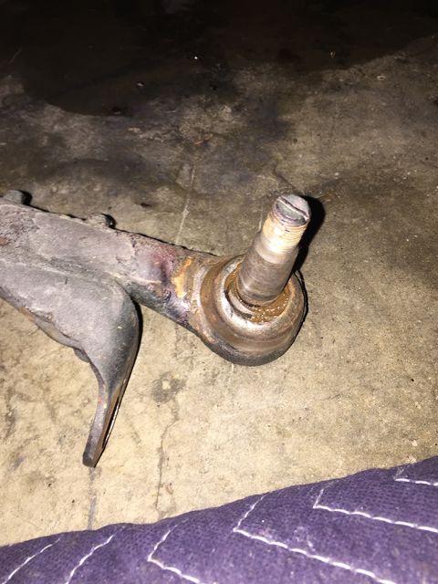 1978 Ford Bronco - This is a close-up view of a ball joint and control arm, likely a vehicle suspension component.