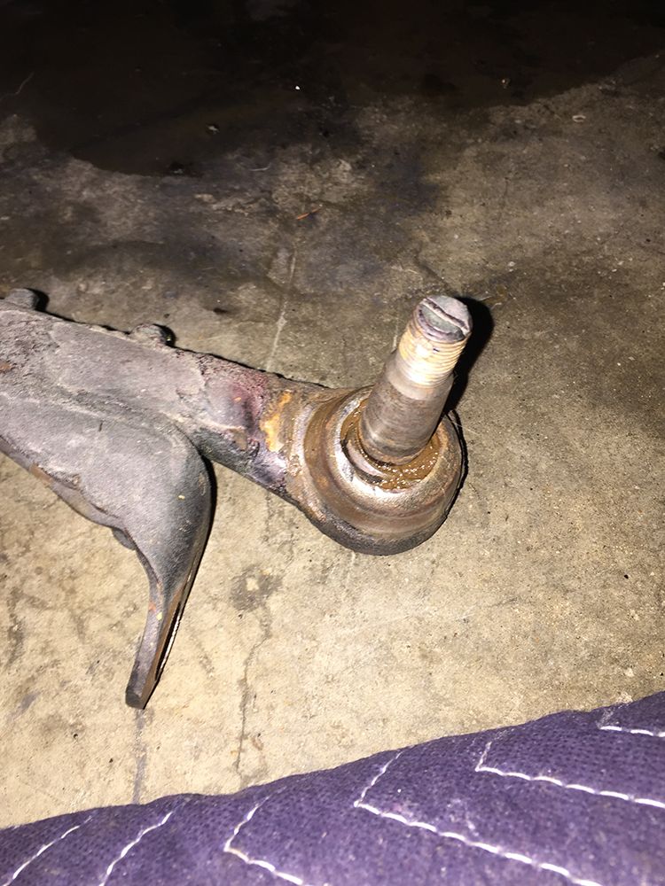 Close-up of a worn ball joint attached to a control arm