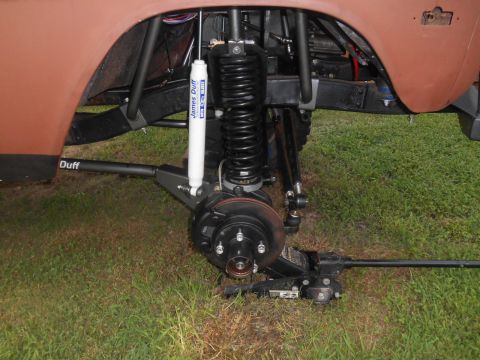 1972 Ford Bronco - Close-up of the 1972 Ford Bronco's front suspension system, showing upgraded shocks and a jack.