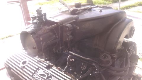 1996 Ford Bronco - Close-up of a Ford V8 engine, likely undergoing a rebuild or modification, with specialized valve covers.