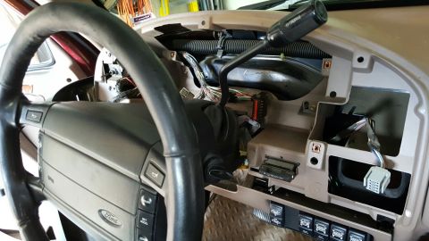 1996 Ford Bronco - Dashboard interior with steering wheel and exposed wiring. The SuperMotors logo is visible at the bottom.