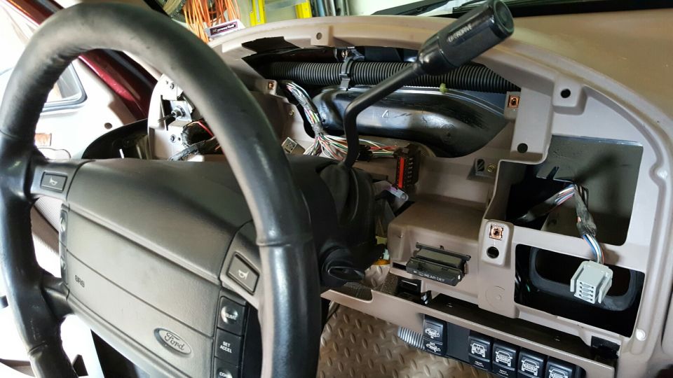 Interior dashboard with exposed wiring and steering wheel. SuperMotors logo visible