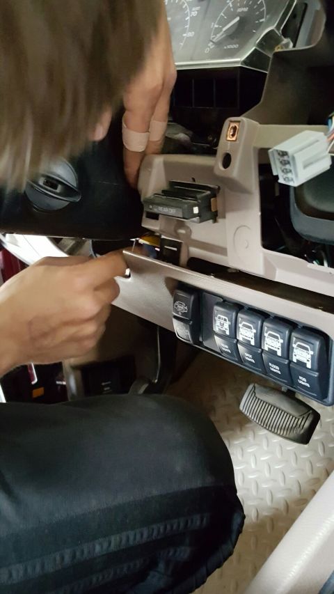 1996 Ford Bronco - A person is working on the dashboard, interacting with various switches and the instrument panel.