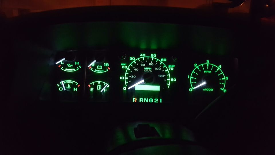 1996 Ford Bronco dashboard gauges with green illumination. Speedometer reads 0 MPH
