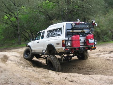 1989 Ford Bronco - This modified Toyota Tacoma is equipped for off-road adventures with extra fuel cans and a roof rack.