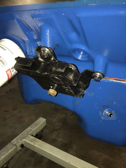 1978 Ford Bronco - Close-up of an engine block with an oil filter and mounting bracket. The engine appears to be on a stand.