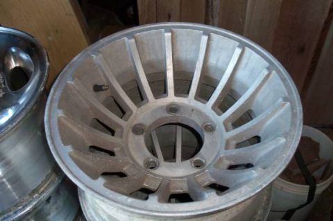 1995 Ford Bronco - A single aluminum alloy wheel is shown, with another wheel partially visible in the background.