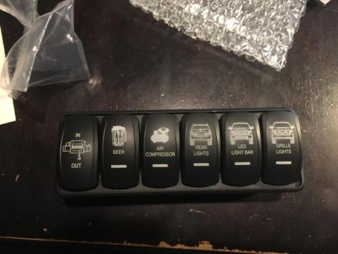 1996 Ford Bronco - This rocker switch panel features labels and icons for various accessories, including a winch, air compressor, and different lighting optio…