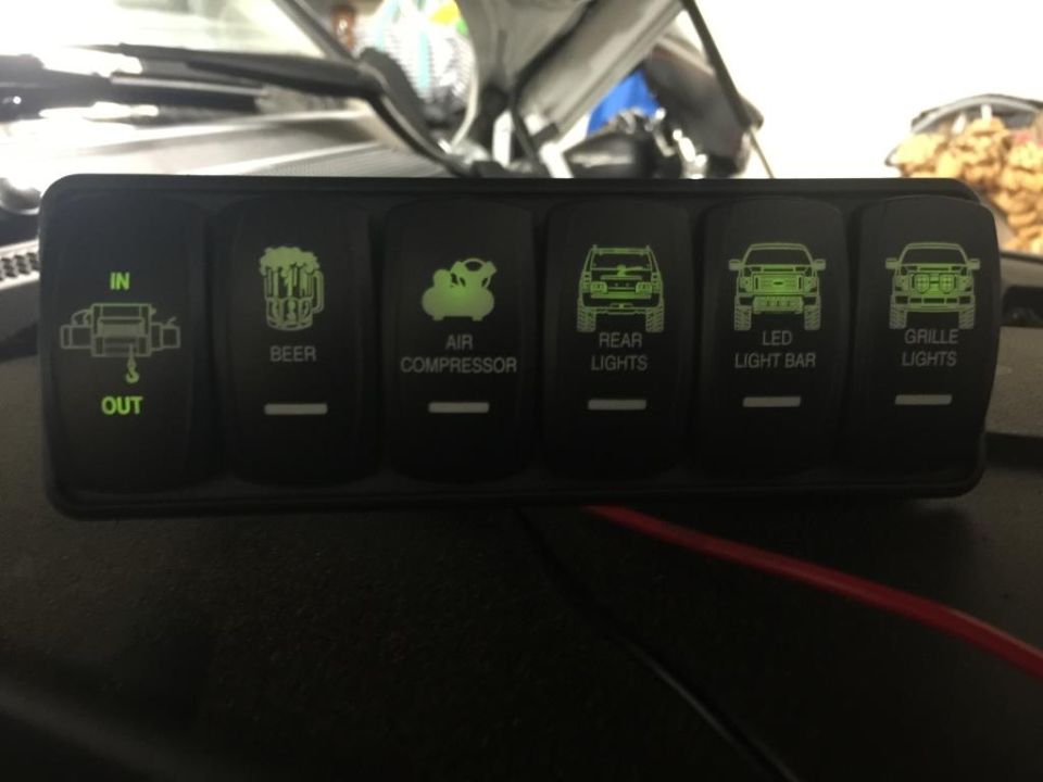 Rocker switch panel with icons for winch, beer, air compressor, rear lights, LED light bar, and grille lights