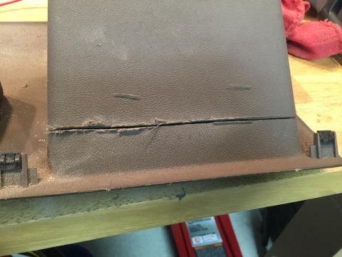 1996 Ford Bronco - Interior trim panel shows damage along a horizontal seam, with frayed material visible.