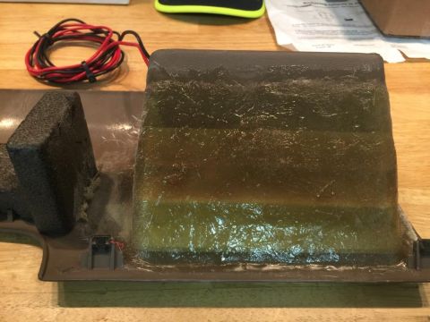 1996 Ford Bronco - A car interior part, possibly a switch housing, is shown with attached foam and wiring.