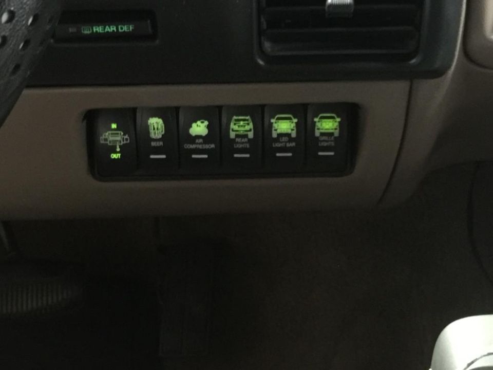 dashboard with rocker switches for air compressor, rear lights, light bar, and other lights