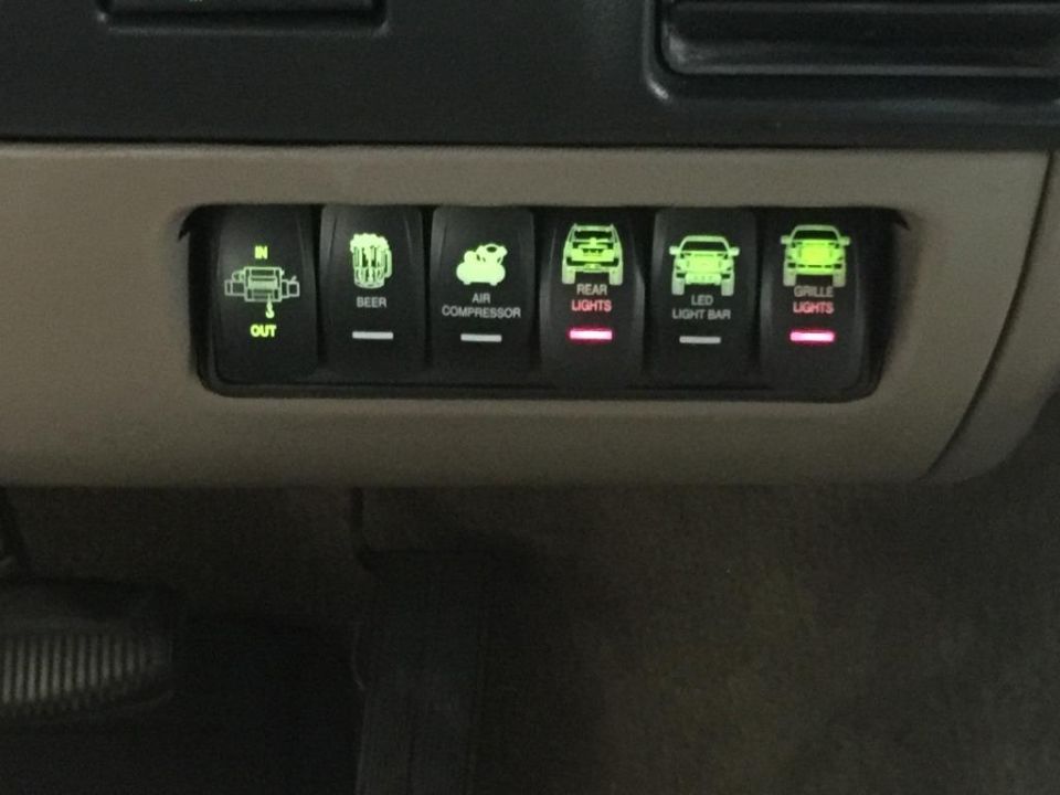 Interior rocker switches labeled 'OUT', 'BEER', 'AIR COMPRESSOR', 'REAR LIGHTS', 'LED LIGHT BAR', and 'GRILLE LIGHTS'