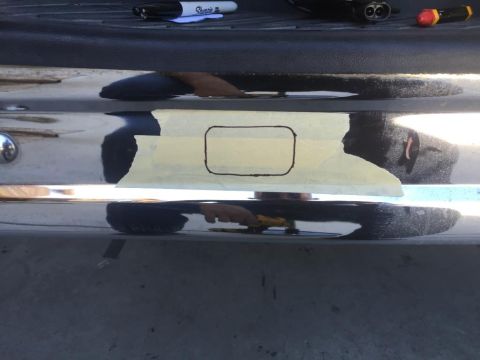 1996 Ford Bronco - Masking tape and marker outline on a vehicle's chrome bumper section.