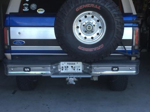 1996 Ford Bronco - Rear view of a 1996 Ford Bronco, showing the bumper, spare tire, and Texas license plate.