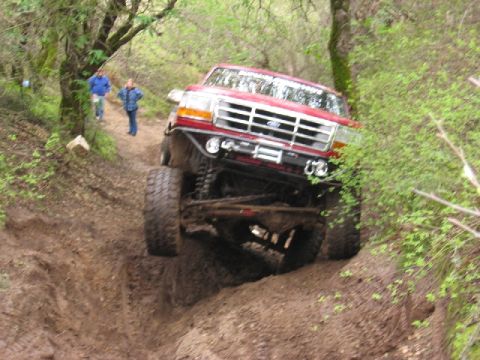 1989 Ford Bronco - This modified 1992 Ford F-Series truck navigates a steep, muddy off-road course.