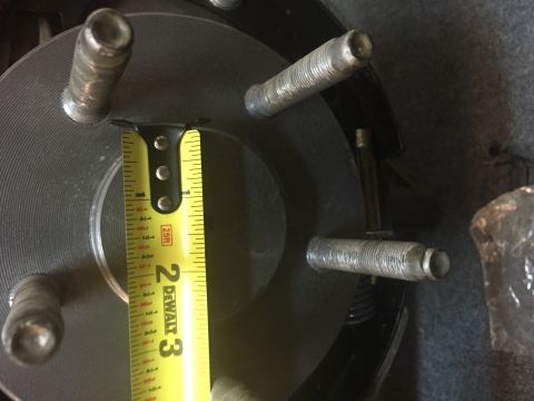 1930 Ford Coupe - A tape measure is used to gauge the dimensions of a vehicle's wheel hub and lug bolts.