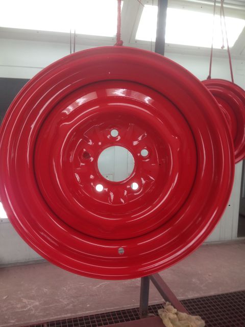 1964 Ford Fairlane - A red painted steel wheel rim is shown hanging, possibly after being refinished.