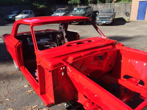 1964 Ford Fairlane - The body of a red 1964 Ford Fairlane is shown from a 3q-front perspective, undergoing restoration.