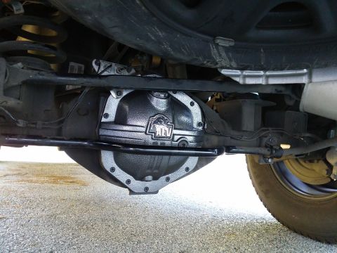 2000 Ford Crown Victoria - The underside of a vehicle shows a custom differential cover with the AEV logo visible.