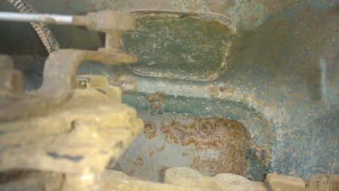 1996 Ford Bronco - Factory cut out plate located, bottom of truck and looking up. Two large threaded holes on transmission are for the shift bracket mounting…