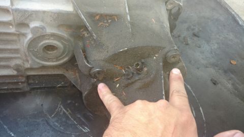 1996 Ford Bronco - Pointing at 2 of the 4 bolts holding the tail housing on for the Manual case. These torx bolt will have to be removed to gain access to int…