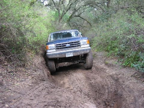 1989 Ford Bronco - This 1989 Ford Bronco navigates a challenging muddy off-road trail.