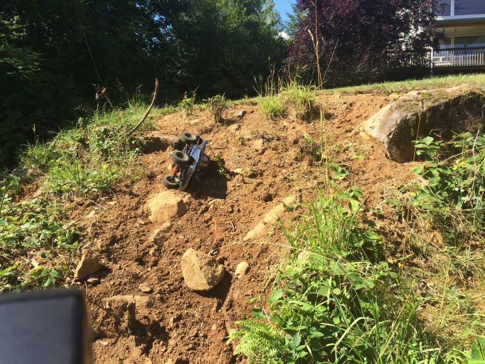 toy truck tipped over on a dirt hill