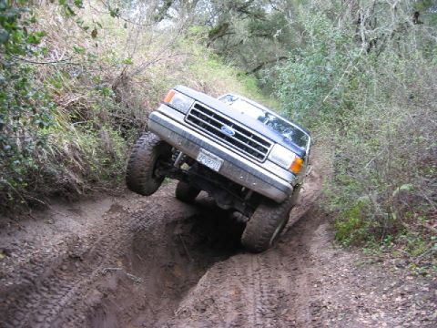 1989 Ford Bronco - This 1989 Ford Bronco tackles a challenging off-road course with one wheel lifted.