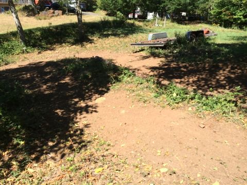 1989 Ford Bronco - A trailer sits in a yard with trees and shadows, suggesting an outdoor storage area.