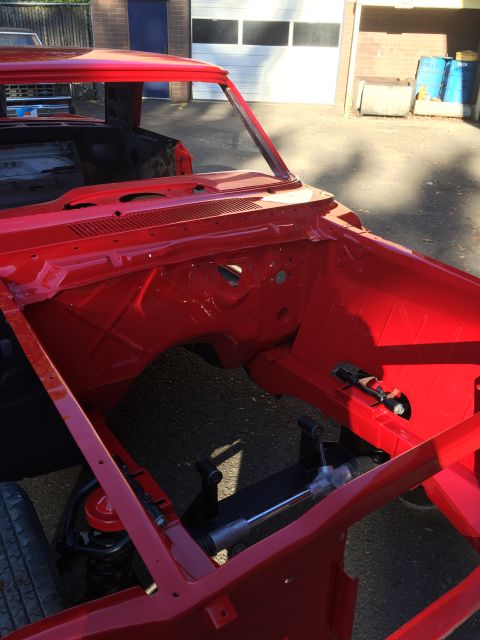 1964 Ford Fairlane - The red chassis of a 1964 Ford Fairlane shows its engine bay and front suspension components.