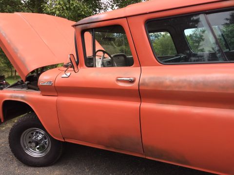 1962 Chevrolet Suburban - This vintage panel truck, likely from the early 1960s, is shown outdoors with its hood raised.