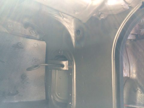 1962 Chevrolet Suburban - Close-up view of an interior panel a metal latch mechanism and perforated sheeting.