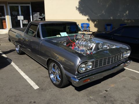 1962 Chevrolet Suburban - Customized 1962 Chevrolet El Camino with a prominent supercharger displayed at a car show.