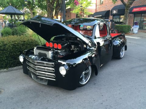 1962 Chevrolet Suburban - Customized pickup truck with a powerful engine on display at a car show.