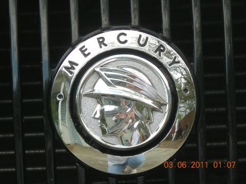 2003 Mercury Marauder - Close-up of a Mercury emblem on a vehicle's grille, with a date stamp visible.