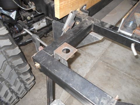 1992 Ford Bronco - This image shows a close-up view of a vehicle's frame, suspension components, and a large tire.