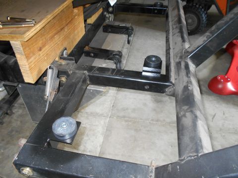 1992 Ford Bronco - Close-up view of a vehicle's frame, showing structural components and a wooden support block.