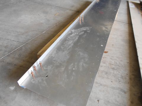 1992 Ford Bronco - Sheet metal panel with rivets and a wooden support on a concrete floor.