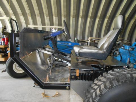 1992 Ford Bronco - Unfinished custom off-road vehicle chassis shows metal fabrication and a single bucket seat.