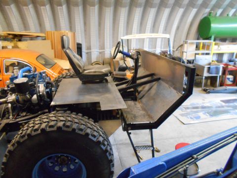 1992 Ford Bronco - Custom off-road vehicle chassis under construction, with an orange VW Beetle in the background.