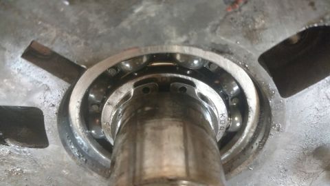 1996 Ford Bronco - Close-up view of a bearing assembly, showing the ball bearings and metal housing. Text 'KOR' is visible on the inner race.