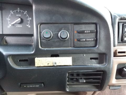 1996 Ford Bronco - Truck dash with an x1000 tachometer, two round switches and 4X4 and Low Range indicator lights.
