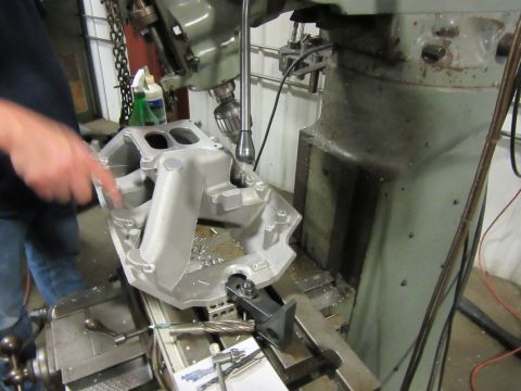 Aluminum intake manifold on milling machine with metal shavings