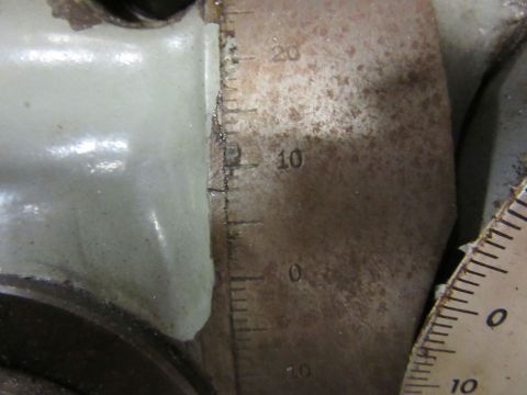 Close-up of a metal scale with markings for 0, 10, and 20, next to a light-colored component