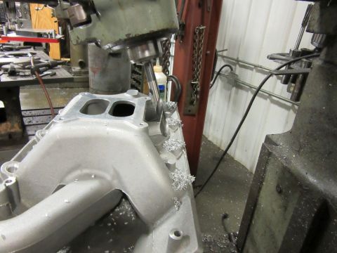 Aluminum intake manifold on a milling machine with metal shavings