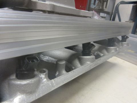 Engine intake manifold with multiple fuel injectors visible