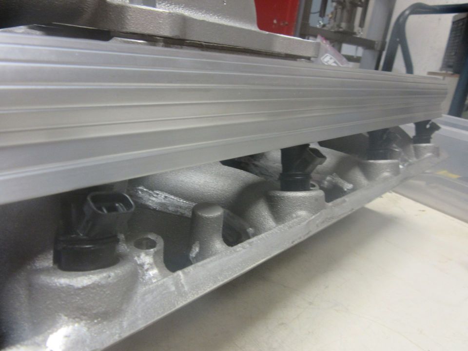Engine intake manifold with multiple fuel injectors visible