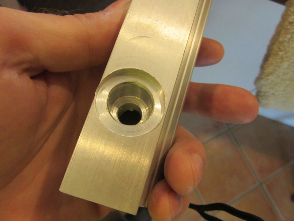 hand holding metal part with a hole