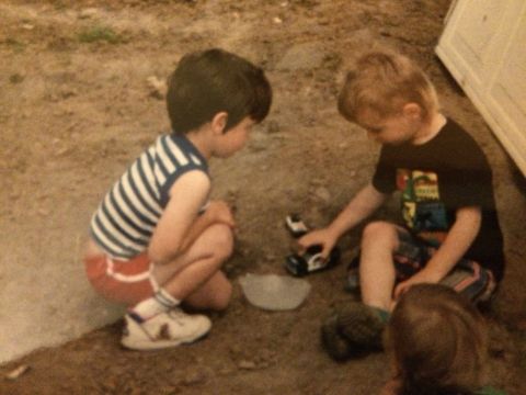 1989 Ford Bronco - Children playing with toy cars outdoors.